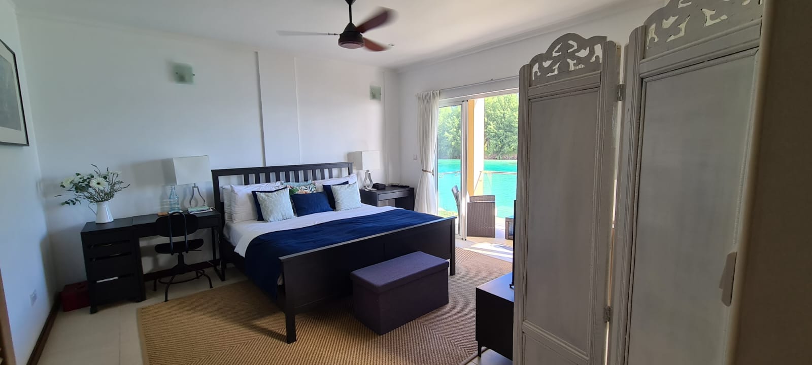 Master bedroom opening toward the sea-view balcony